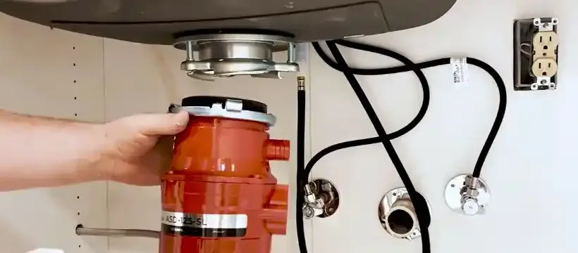 Licensed technician performing garbage disposal repair for a Franklin, TN home