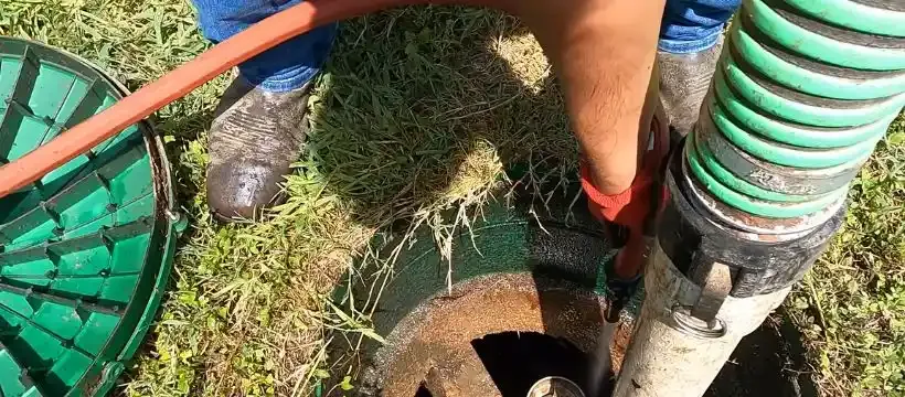 Licensed technician performing septic tank pumping for a Franklin, TN home