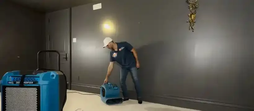 Licensed technician performing water damage restoration for a Franklin, TN home